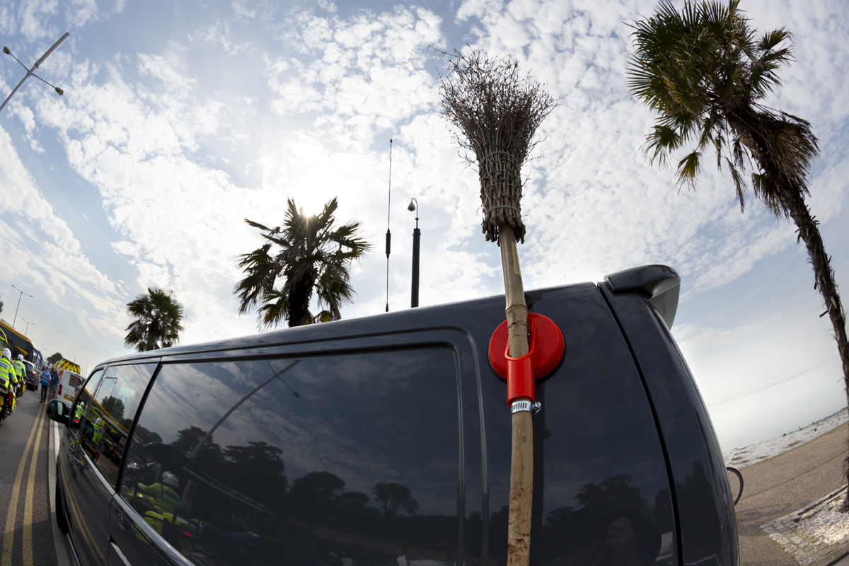 Tour of Britain 2023 - The broom of the Broom Wagon in line with the palms trees on the sea front