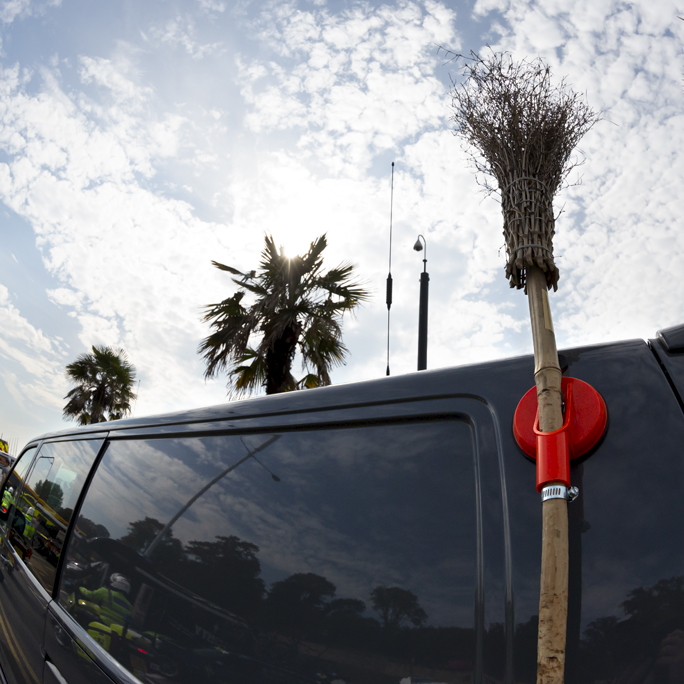 Tour of Britain 2023 - The broom of the Broom Wagon in line with the palms trees on the sea front