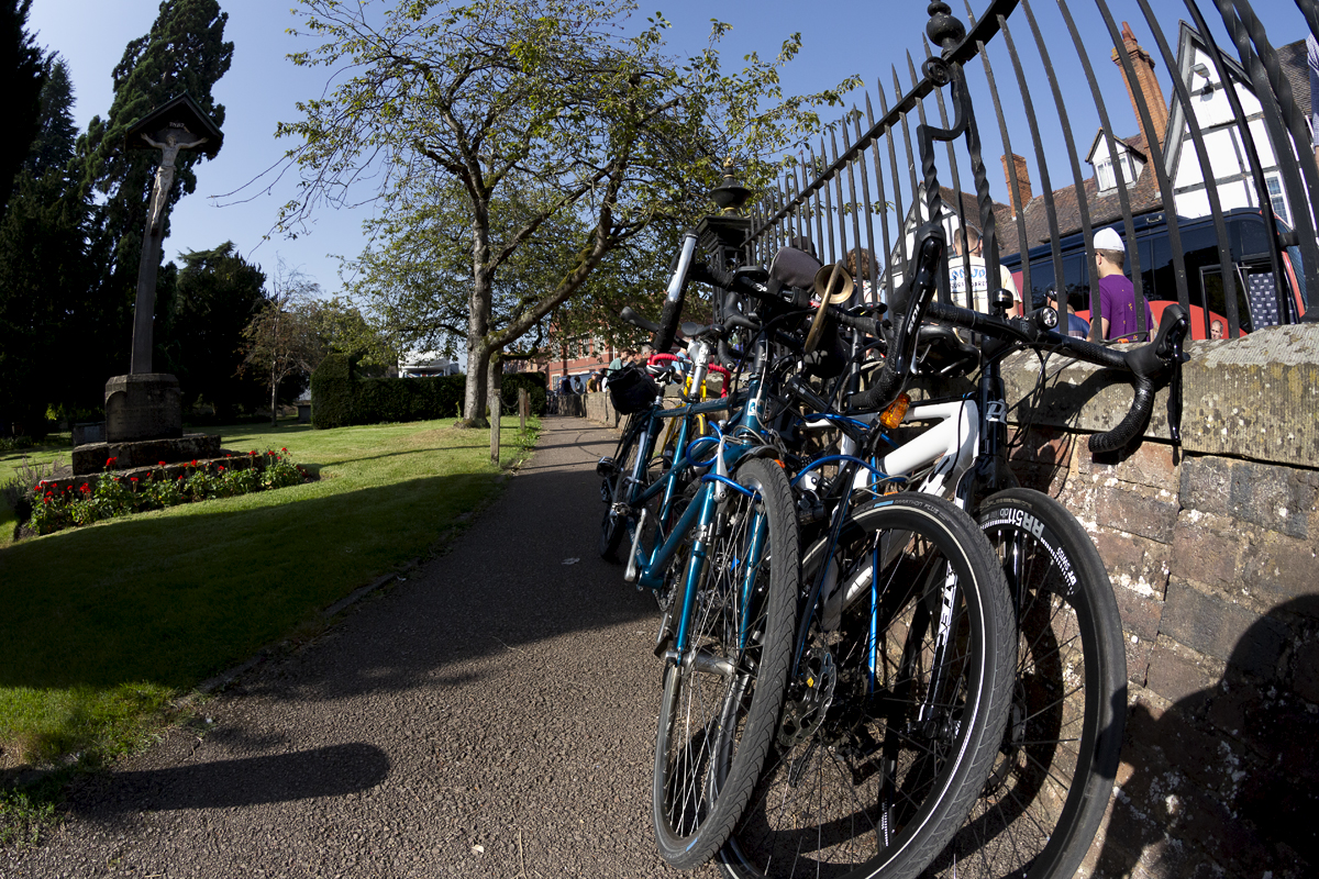 Tour of Britain 2023 - Spectators’ bikes are leant up against the railings at Tewkesbury Abbey