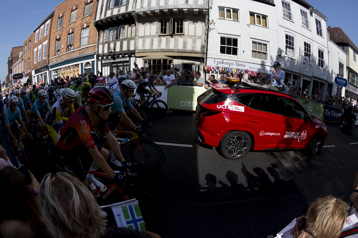 Tour of Britain 2023 - The race follows the race car out of the shadows and through the streets of Tewkesbury