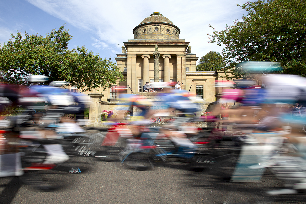 Tour of Britain 2024 - The race speeds past Greenlaw Town Hall in the Scottish Borders