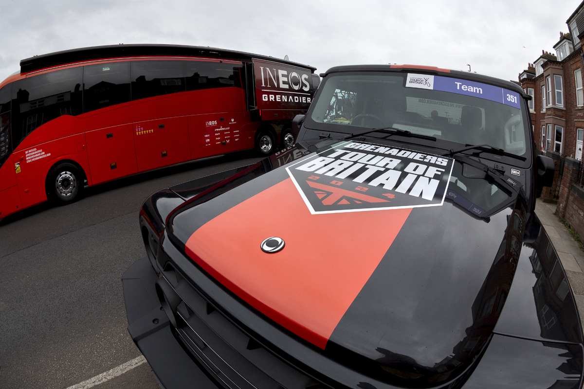 Tour of Britain 2024 - An INEOS Grenadier SUV is seen on Redcar sea front with the INEOS team bus in the background