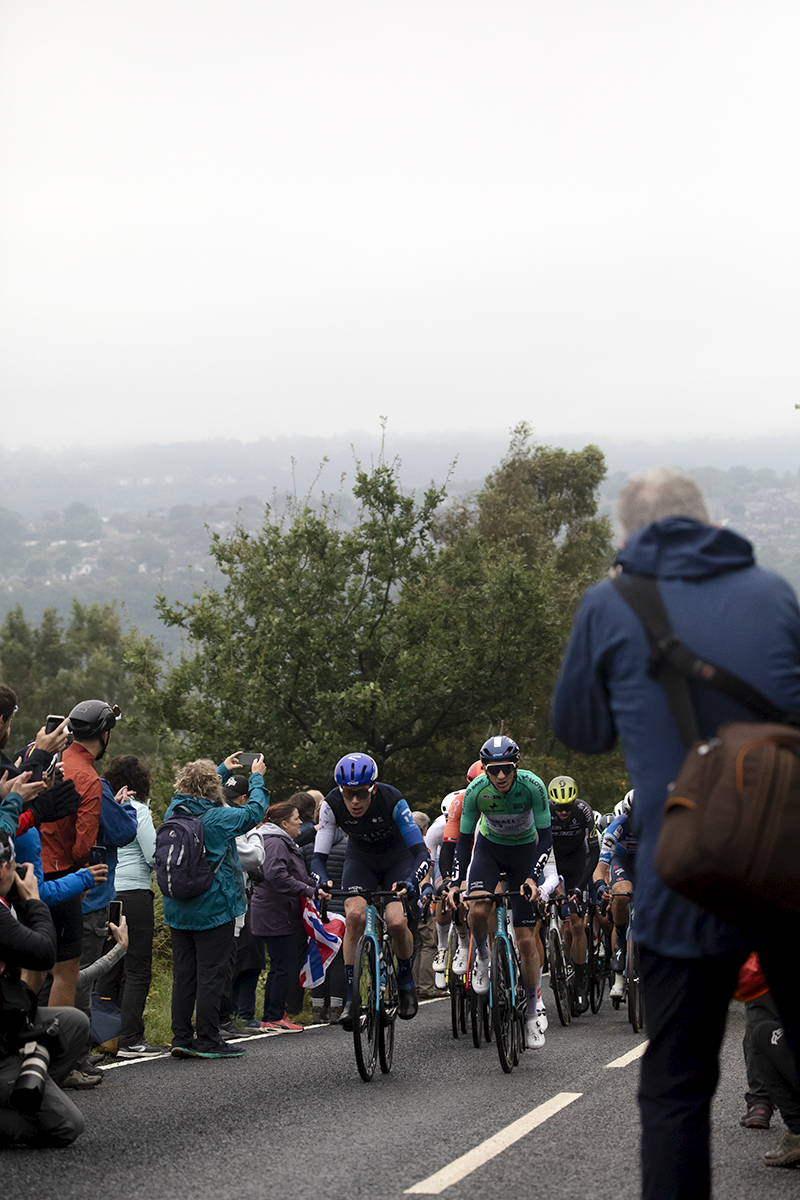 Tour of Britain 2024 - Riders tackle the Long Lane climb along roads lined with fans on a misty morning in South Yorkshire