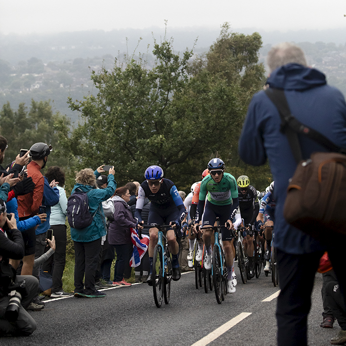 Tour of Britain 2024 - Riders tackle the Long Lane climb along roads lined with fans on a misty morning in South Yorkshire