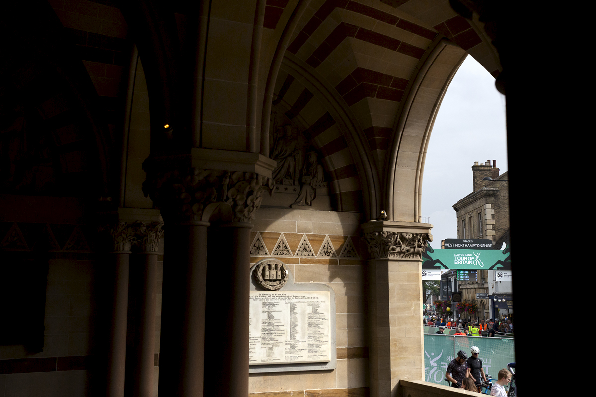 Tour of Britain 2024 - The finish gate at Northampton viewed through the arched doorway of the town hall