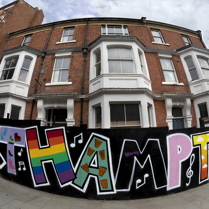 Tour of Britain 2024 - A hoarding with Northampton written on it in graffiti style