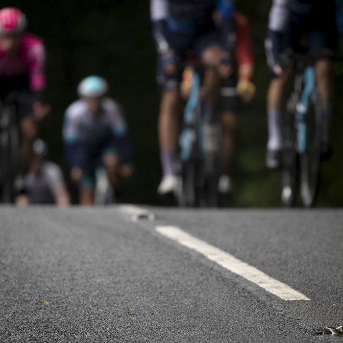 Tour of Britain 2024 - The early signs of Autumn are seen in the shape of a fallen leaf on the road as the peloton approaches outside Wentworth Castle