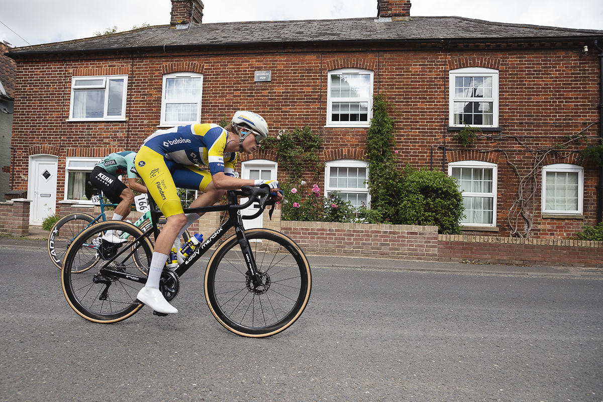 Tour of Britain 2025 - Victor Vercouillie rides past a row of cottages in Wickham Market