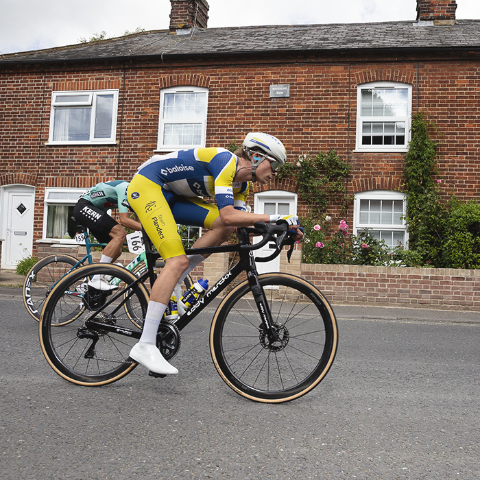 Tour of Britain 2025 - Victor Vercouillie rides past a row of cottages in Wickham Market