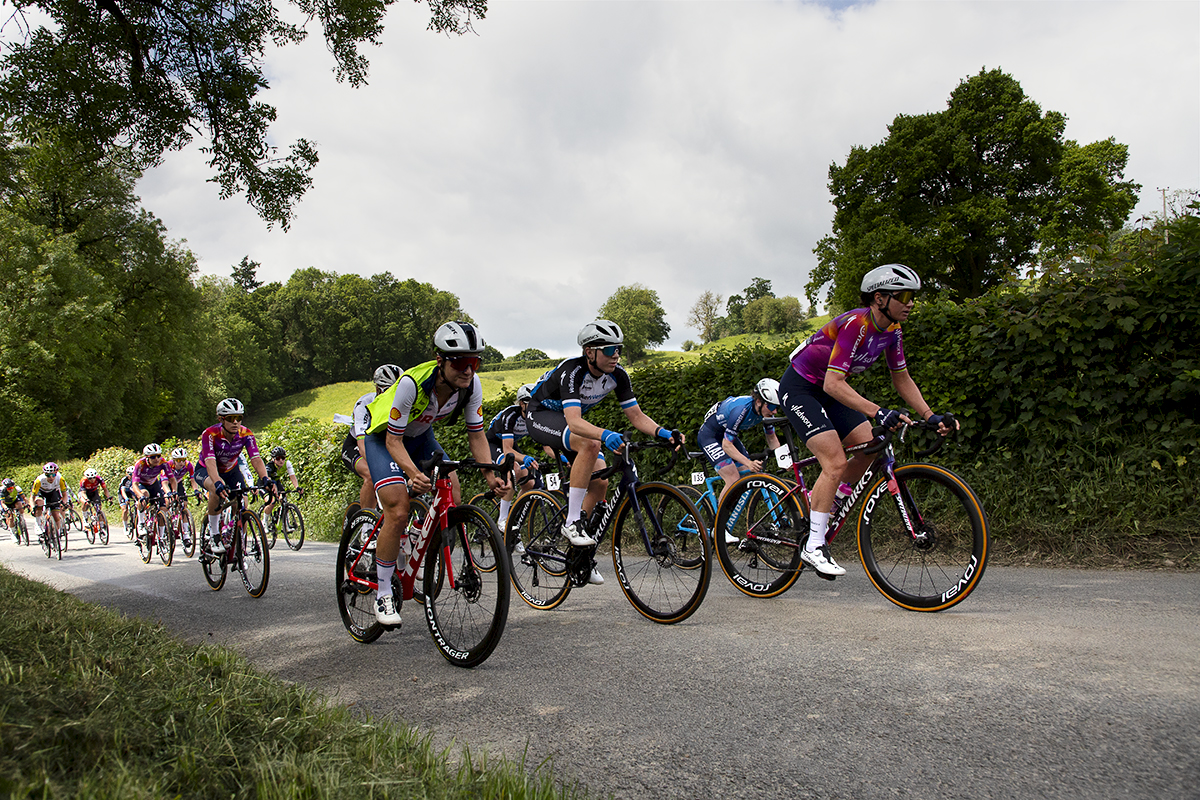 Tour of Britain Women’s 2024 - The peloton climbs a hill in the Welsh countryside