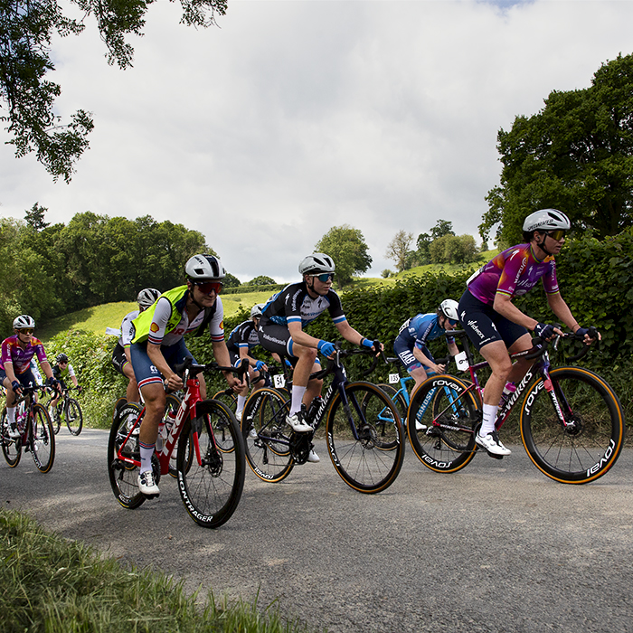 Tour of Britain Women’s 2024 - The peloton climbs a hill in the Welsh countryside