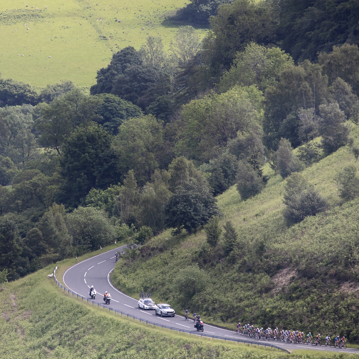 Tour of Britain Women’s 2024 - Riders seen from a distance taking on Horseshoe Pass