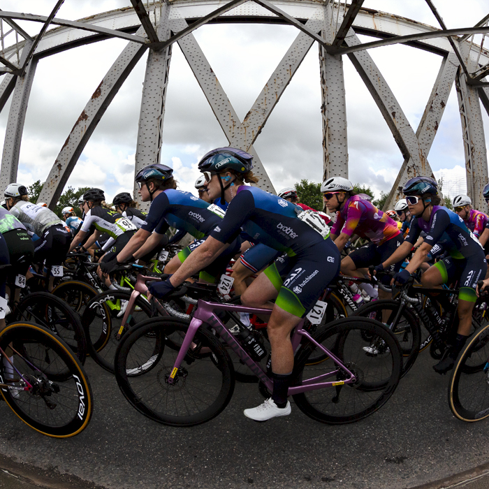 Tour of Britain Women’s 2024 - Riders seen from the side as they cross an old swing bridge in Warrington