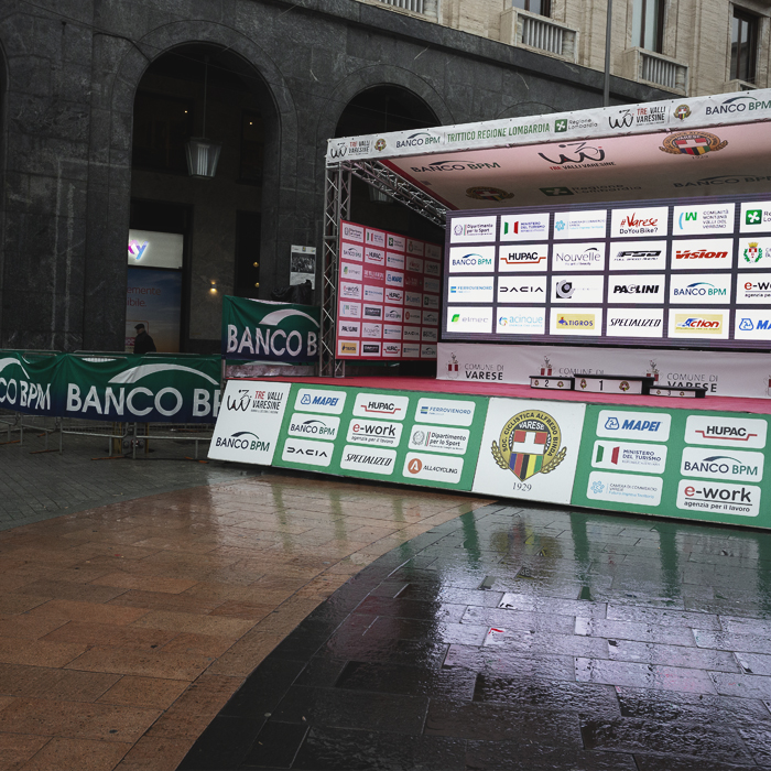 Tre Valli Varesine 2024 - The empty podium reflects in the puddles following the abandonment of the race