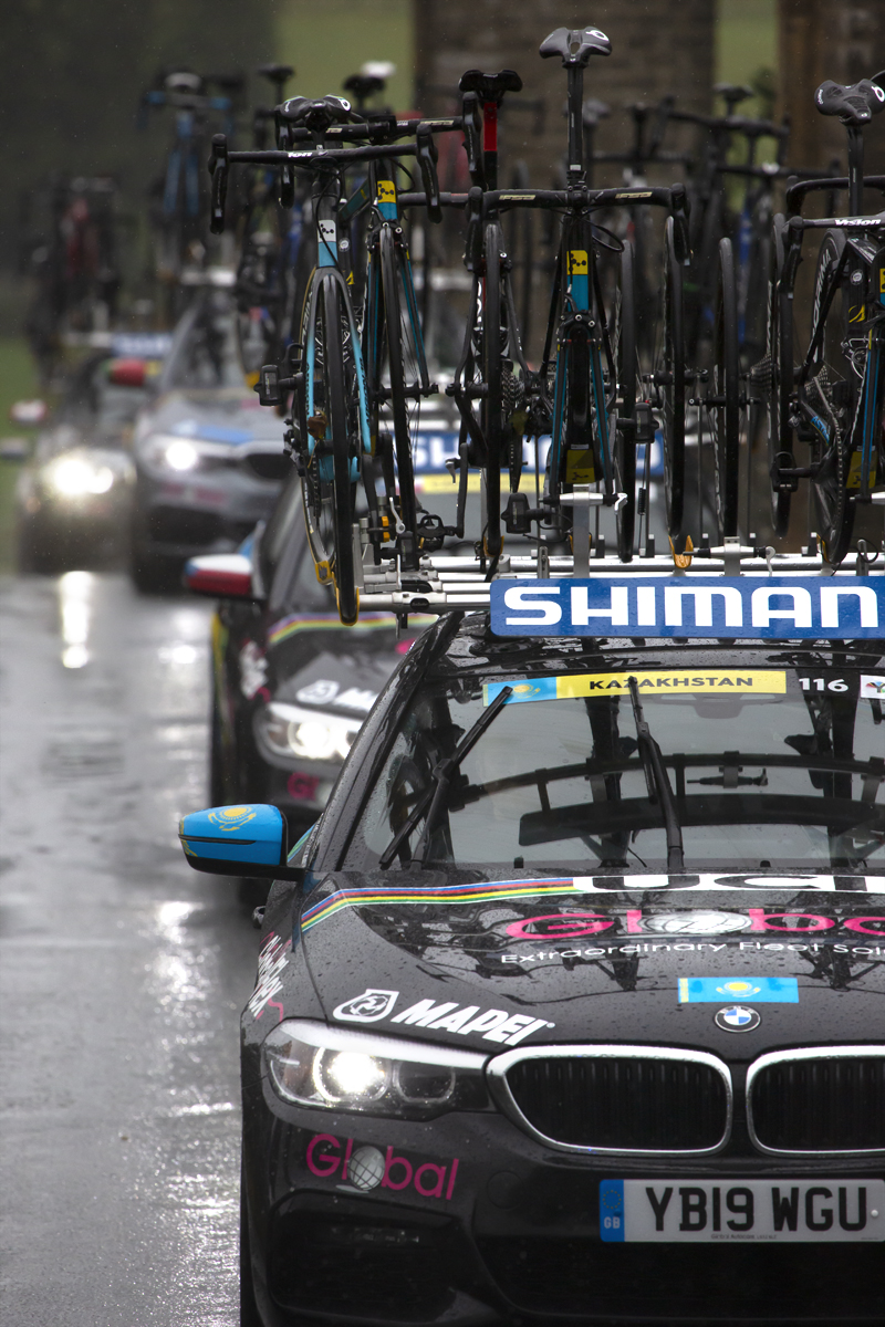 UCI 2019 Road World Championships - team cars with bikes on the roof move through the rain