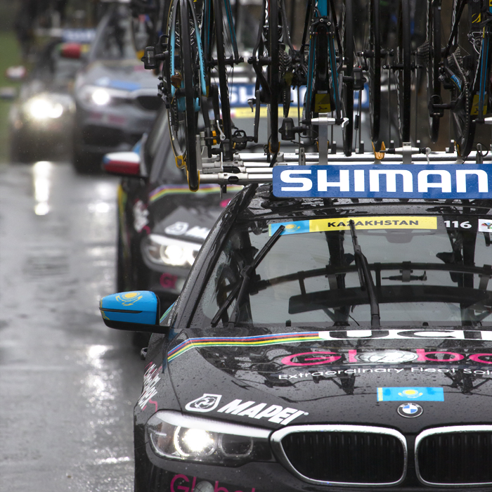 UCI 2019 Road World Championships - team cars with bikes on the roof move through the rain