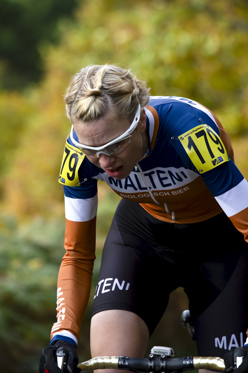 UK National Hill Climb Championships 2015 - Claire Munton stands up on her pedals with autumnal shades behind her