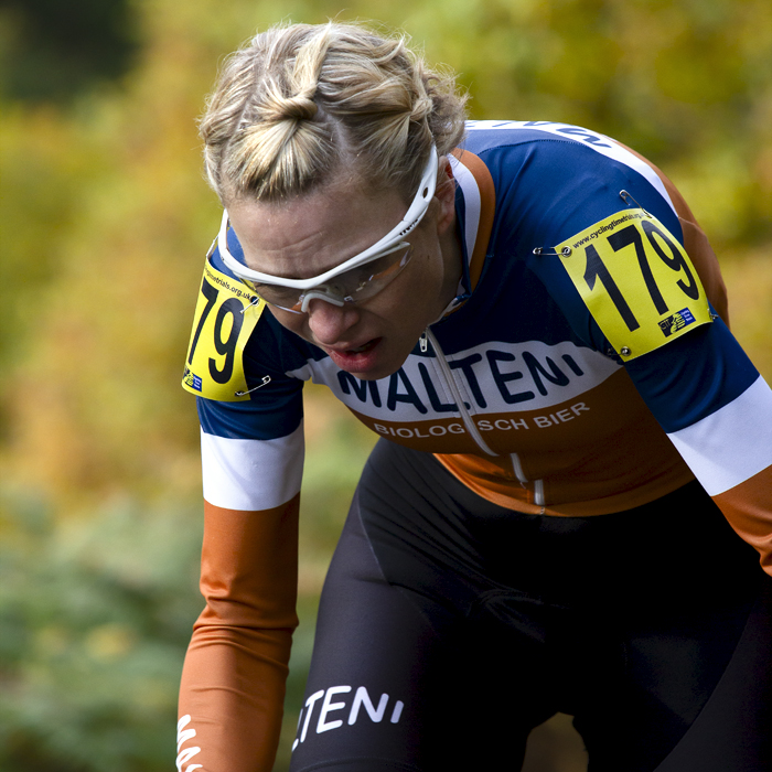 UK National Hill Climb Championships 2015 - Claire Munton stands up on her pedals with autumnal shades behind her