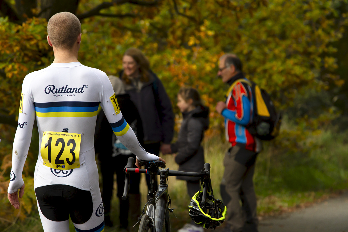 UK National Hill Climb Championships 2015 - Rear view of Sam Smith as he walks with his bike down the hill through autumnal leaves