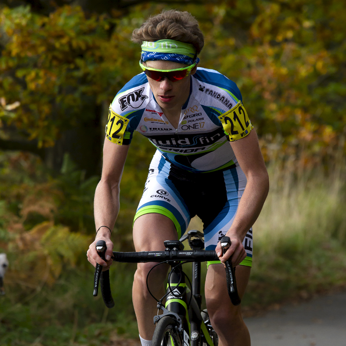 UK National Hill Climb Championships 2015 - Tom Bell wearing green sunglasses and headband climbs the hill