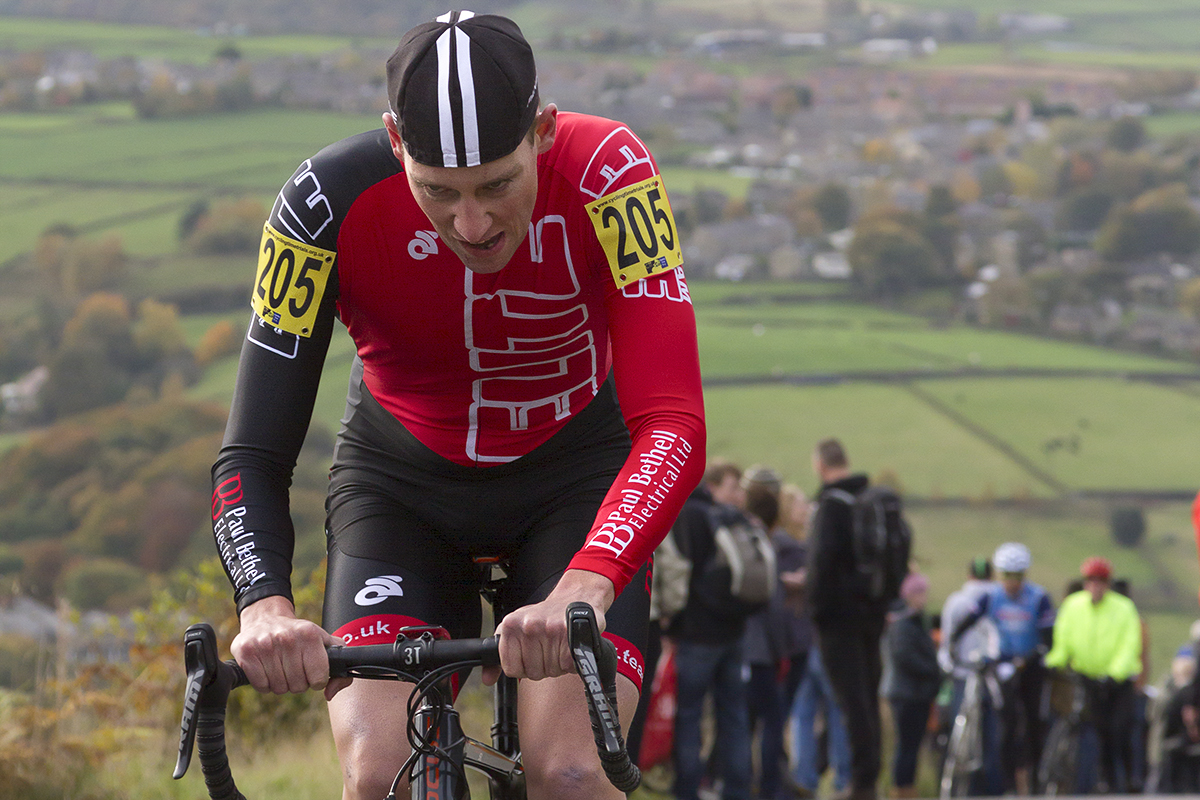 UK National Hill Climb Championships 2015 - Tom Brazier looks down and grimaces with countryside view of Yorkshire