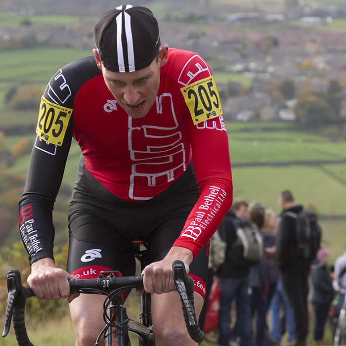 UK National Hill Climb Championships 2015 - Tom Brazier looks down and grimaces with countryside view of Yorkshire