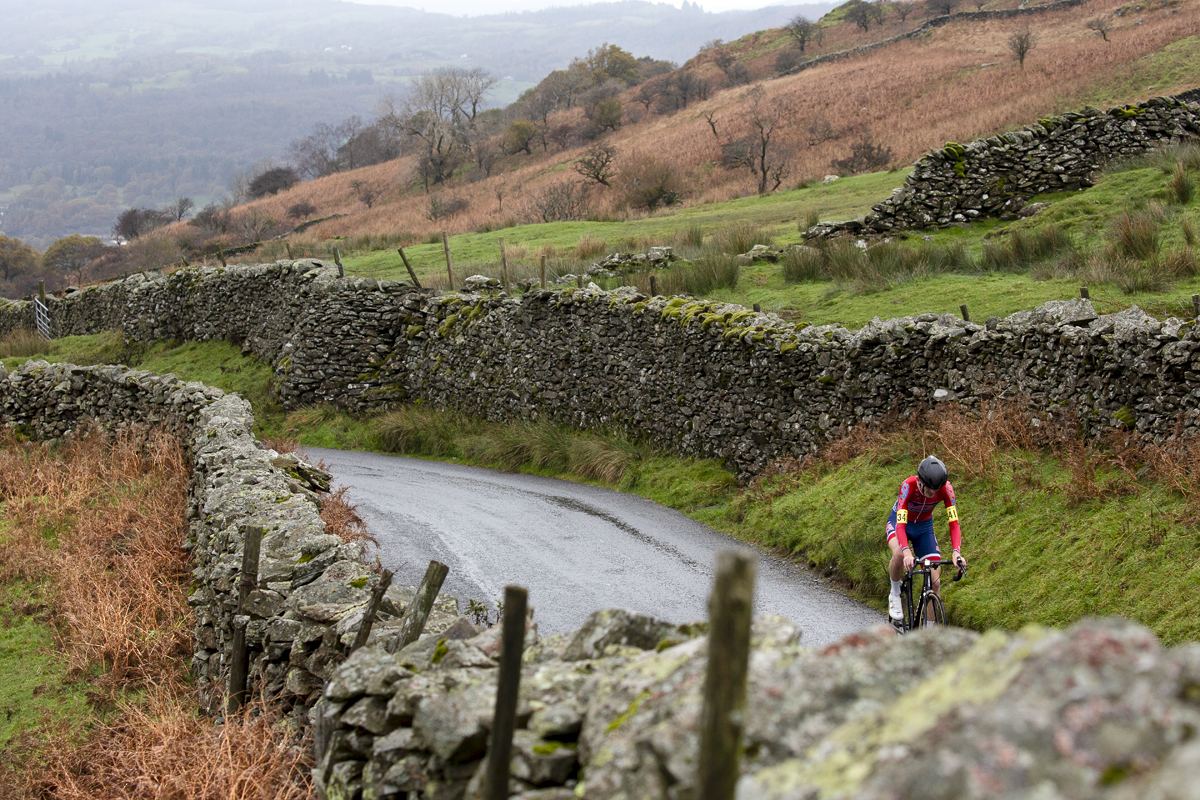 UK National Hill Climb Championships 2023 - Ben McKie passes by dry stone walls with the countryside in the background