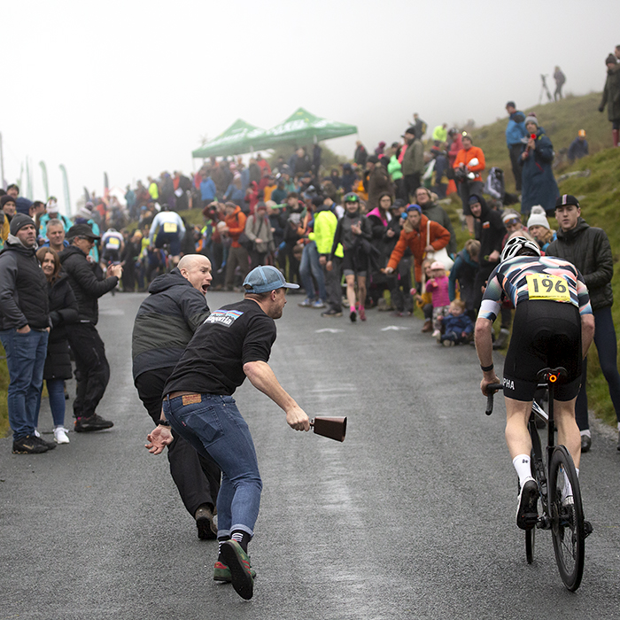 UK National Hill Climb Championships 2023 - Throngs of supporters line the roads as Sean Nicholls is encouraged by tow fans running alongside him