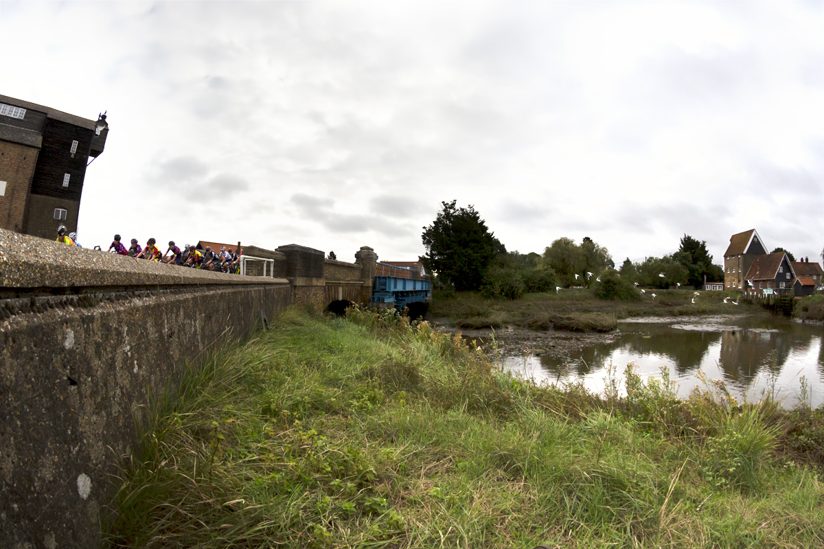 Women’s Tour 2021 - The peloton rides across the bridge with the Mill in the background