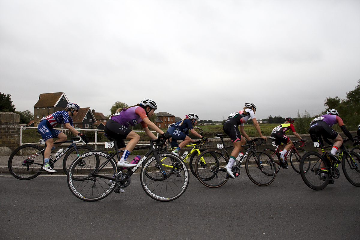 Women’s Tour 2021 - The riders round the corner with the river in the background