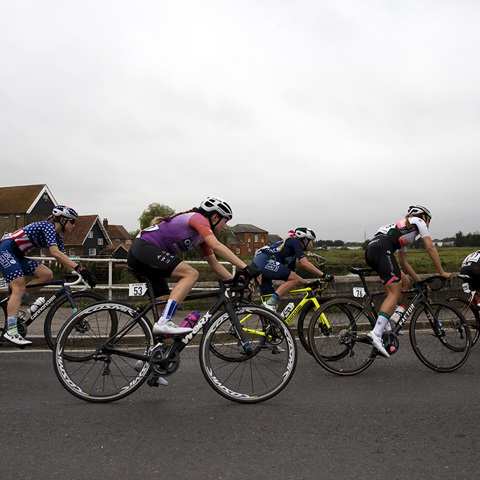 Women’s Tour 2021 - The riders round the corner with the river in the background