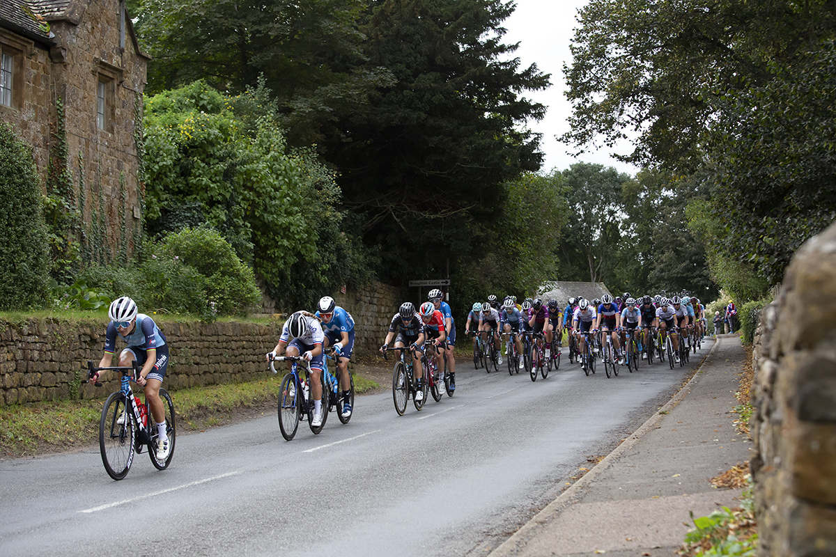 Women’s Tour 2021 - The peloton passes a tradtiional row of stone built cottages