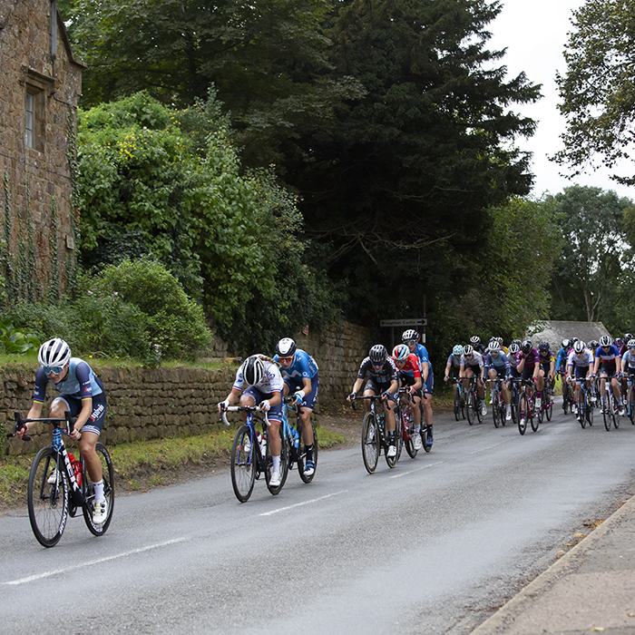 Women’s Tour 2021 - The peloton passes a tradtiional row of stone built cottages