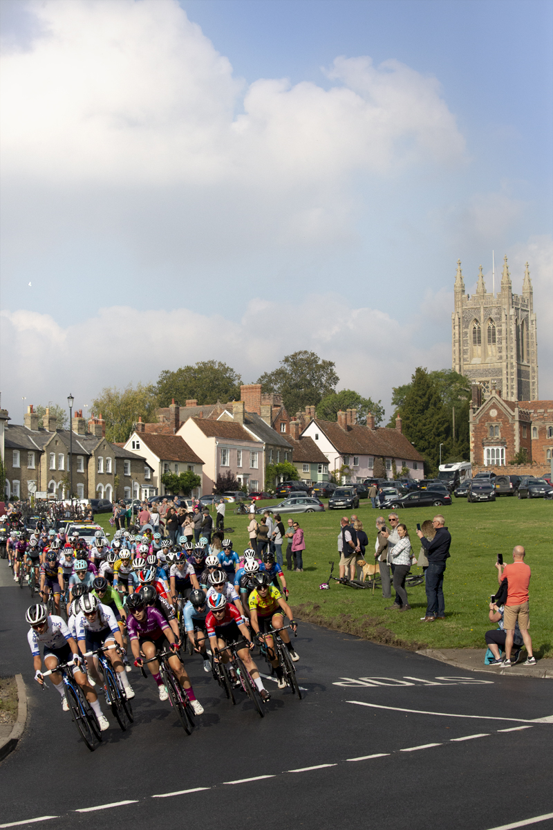 Women’s Tour 2021 - The peloton passes through the traditional village of Long Melford with the church in the background