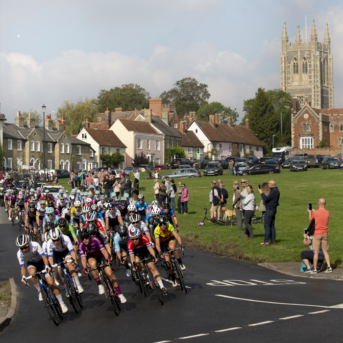 Women’s Tour 2021 - The peloton passes through the traditional village of Long Melford with the church in the background