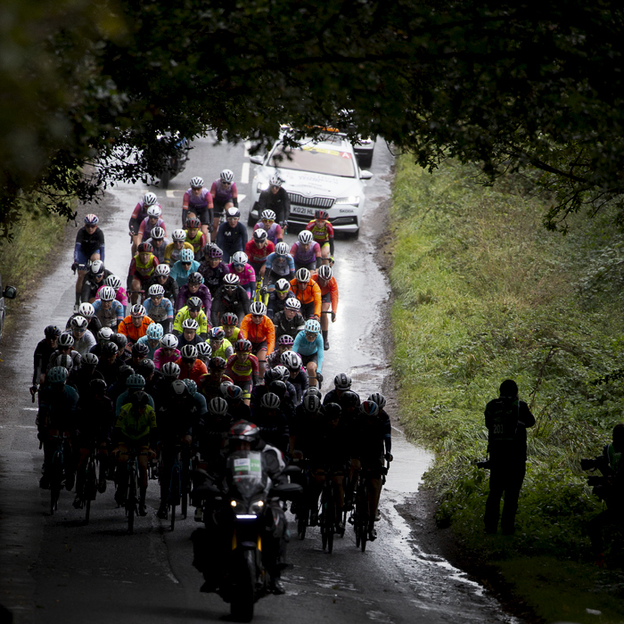 Women’s Tour 2021 - The peloton is silhouetted on wet tree lined roads