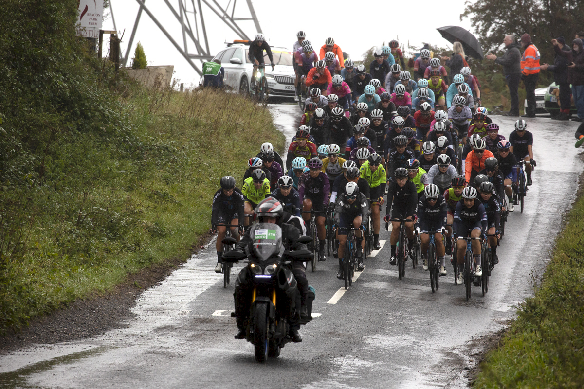 Women’s Tour 2021 - The riders descend a wet hill with a pylon in the background