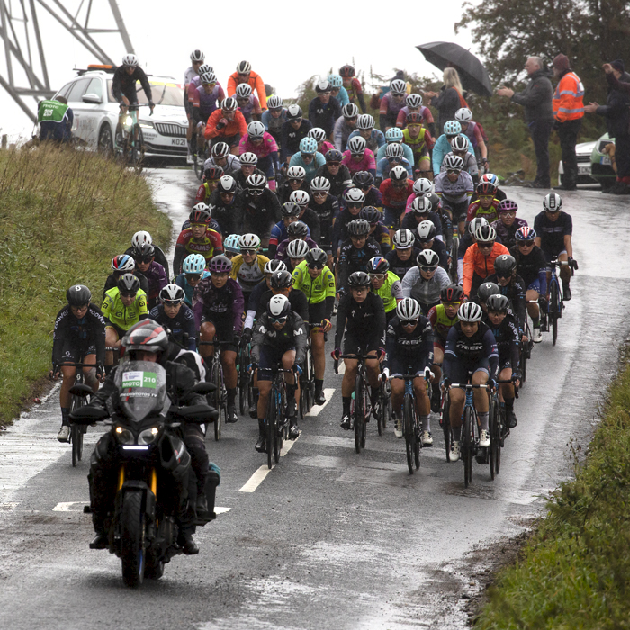 Women’s Tour 2021 - The riders descend a wet hill with a pylon in the background