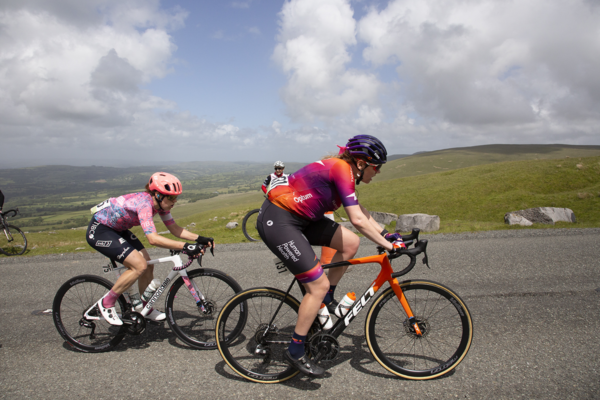 Women’s Tour 2022 - Riders pass fans at the side of the road with a view stretching away into the distance