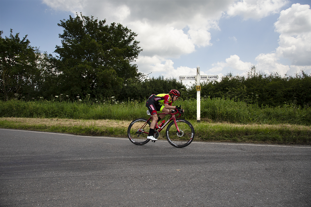 Women’s Tour 2022 -Sammie Stuart of CAMS-Basso passes a traditional white road sign in the countryside