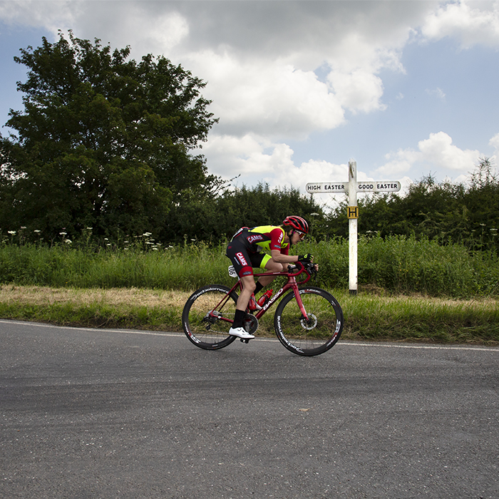 Women’s Tour 2022 -Sammie Stuart of CAMS-Basso passes a traditional white road sign in the countryside