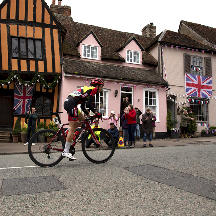 Women’s Tour 2022 - Danielle Shrosbree of Cams Basso climbs past the Crooked House, an old half timber Tudor house in Lavenham