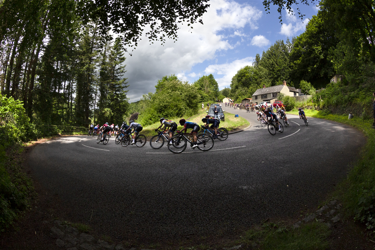 Women’s Tour 2022 - The peloton take on a switchback on the descent in Lydbrook, Forest of Dean